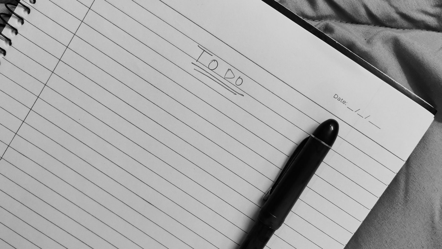 An organised document-review workspace with a notebook and pen